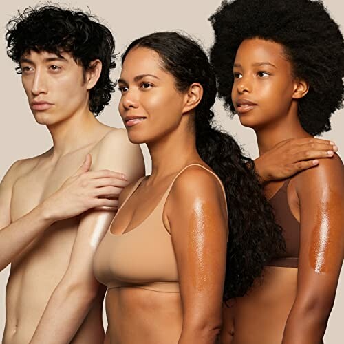 Three diverse individuals with healthy skin posing together.