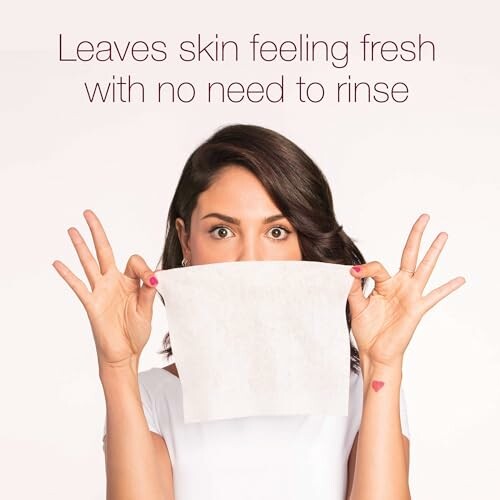Woman holding face wipe with text 'Leaves skin feeling fresh with no need to rinse'.